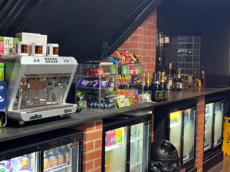 The bar counter with a coffee machine, snacks, spirits and drinks fridges.